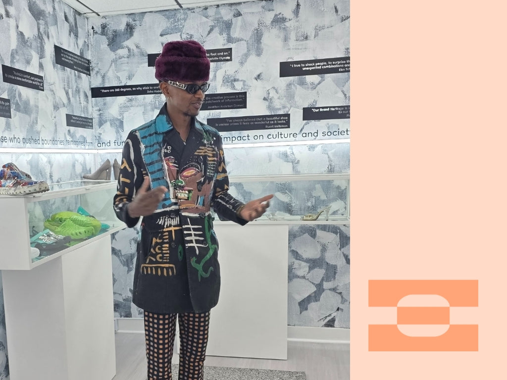 Artist collaborating with IAMBIC speaking inside footwear design exhibit, showcasing creative innovation and cultural impact