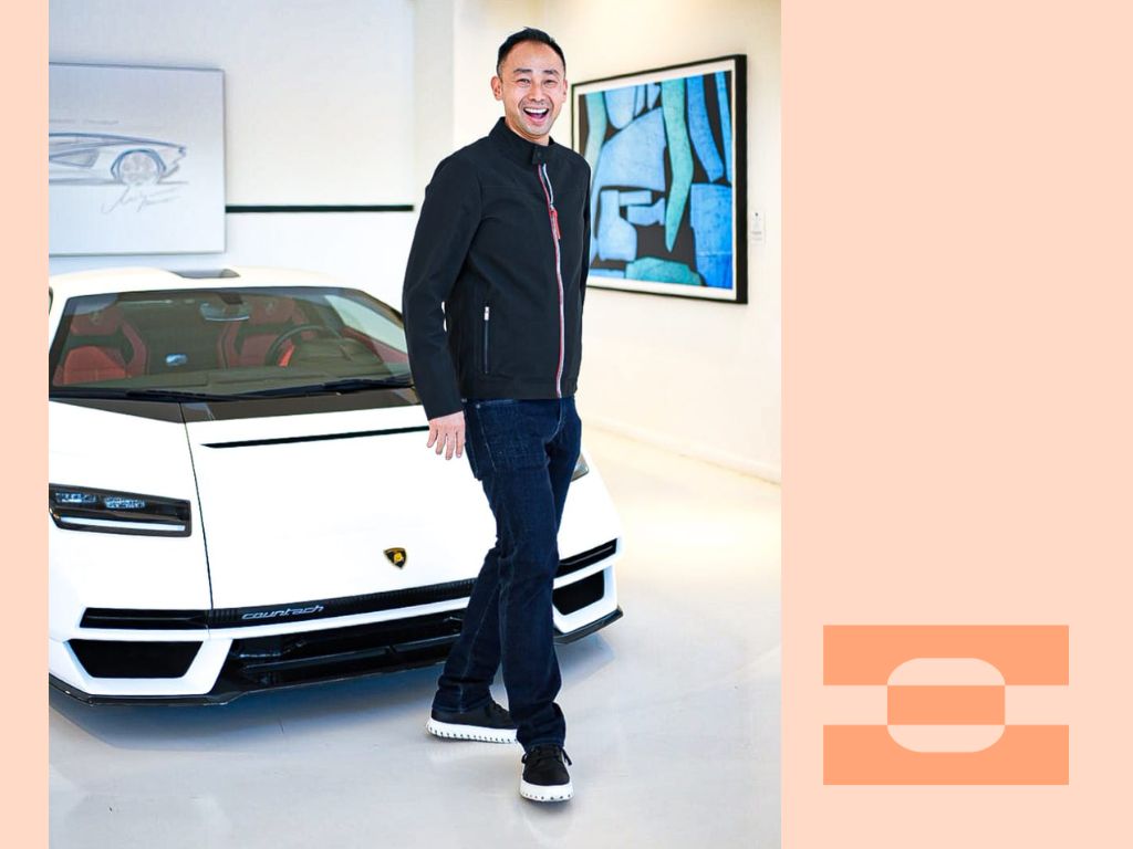 Motorsport Lab founder Ray Chang stepping out of a red supercar wearing IAMBIC MODEL T precision-fit shoes, symbolizing performance, luxury, and comfort engineered for travel.