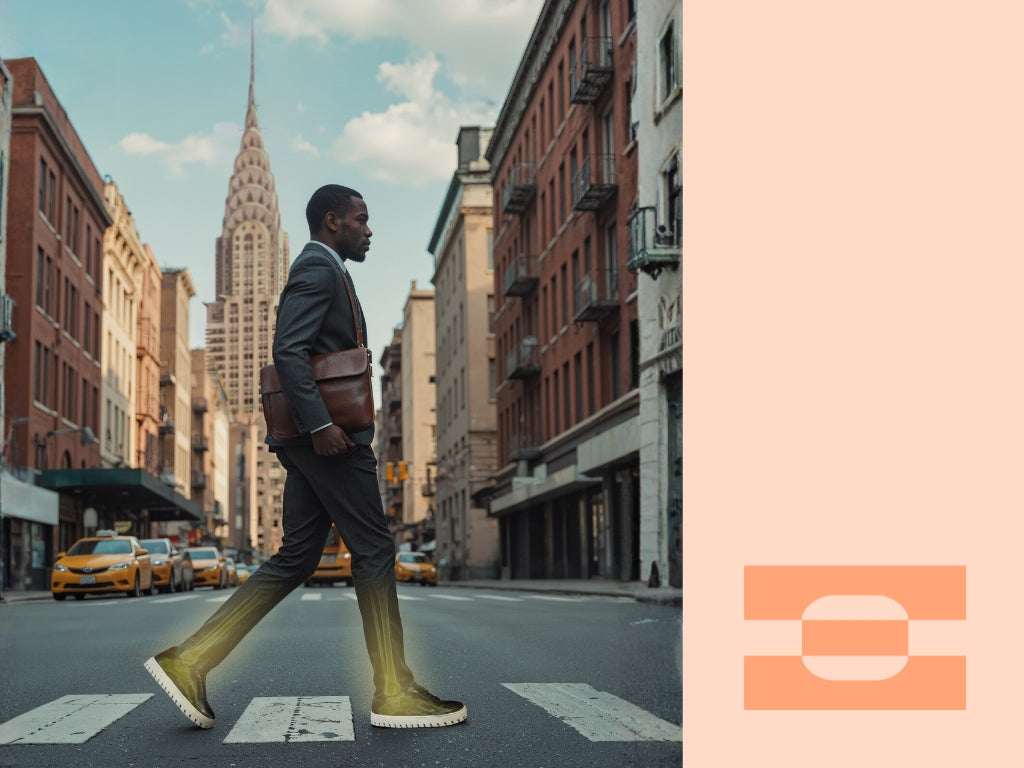Professional man crossing a New York City street wearing IAMBIC MODEL T custom-fit shoes, blending executive style with AI-tailored comfort and performance.