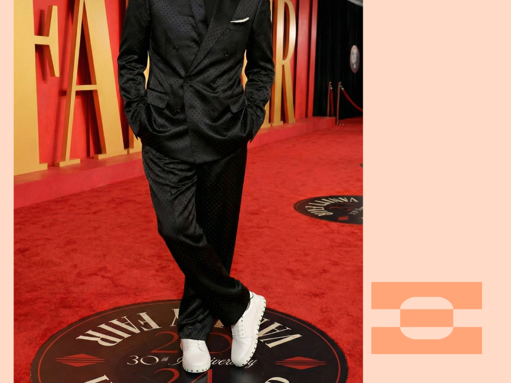 Hollywood executive wearing IAMBIC Model T custom-fit shoes on the red carpet, demonstrating the comfort and precision of AI-tailored footwear.
