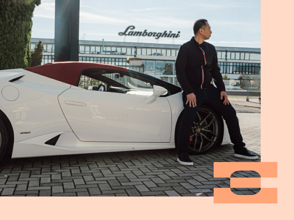 Ray Chang in IAMBIC MODEL T precision-fit shoes outside the Lamborghini factory in Italy, representing the fusion of high-performance engineering and luxury footwear design.